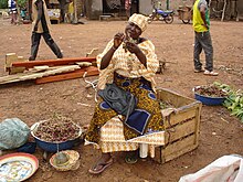 A woman processing Lannea microcarpa fruits in Burkina Faso. Woman processing Lannea microcarpa.jpg