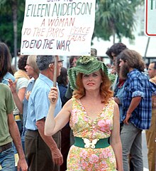 Woman protesting during the 1972 Republican National Convention. Women protestor with sign- Miami Beach, Florida.jpg