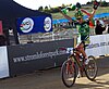 male cyclist crossing the finish line, arms held aloft - Burry Stander winning the under 23 men's XC title at the 2009 UCI Mountain Bike World Championships