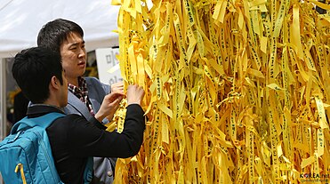 Two people looking at yellow ribbons in Seoul Plaza in 2014. Yellow ribbons at Seoul Plaza in 2014.jpg