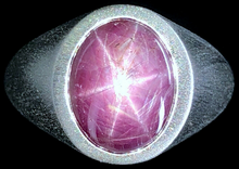A 6.33 carat natural purple-pink star sapphire is mounted in a platinum setting.