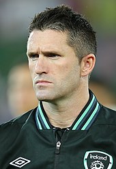 A headshot of a footballer with short dark hair.