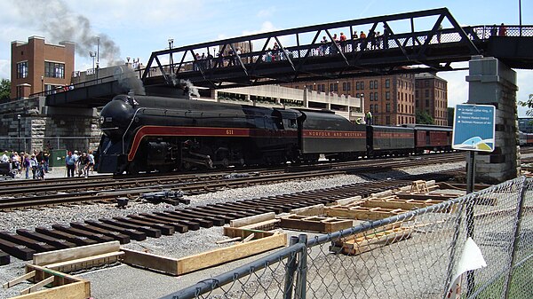 An excursion train run by N&W 611 passes the under-construction platform in May 2017