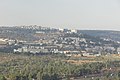 Close to the bottom of the picture is route 1 to Jerusalem. Behind are the Neve Ilan studios. Behind the studios is a north western neighborhood of Abu Gosh. The two large structures behind are the Maale Hamisha hotel. To the left of the hotel is Har Adar.