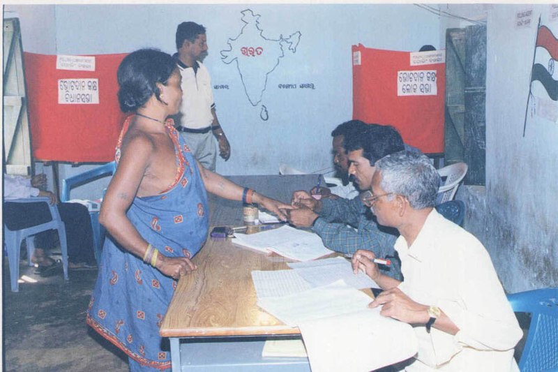 File:An Electoral Officer administering the indelible ink to the finger of a tribal woman at a polling station at Koraput in Orissa, for the first phase of General Elections-2004 on April 20, 2004.jpg