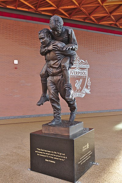 Statue of Bob Paisley carrying the injured former Liverpool captain Emlyn Hughes outside Anfield. Paisley remains the most successful manager in the c