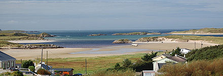 Panoramic view of Magheraclogher beach and Gweedore Bay, also the site of the famous shipwreck, the Cara Na Mara (Friend of the Sea) on the tidal sandbanks. The boat, best known as 'Bád Eddie' (Eddie's Boat), ran ashore due to rough seas in the early 1970s