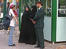 Three police warn a woman to cover her forearms. First vice squad of guidance patrol in Tehran (12 8502020677 L600).jpg