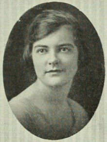 A young white woman with short bobbed hair dressed with a side part, in an oval frame