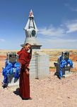 Buddhist monk near the stupa. Shambhala complex, Gobi Desert, Dornogovi Province, Mongolia.