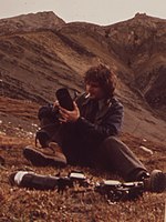 Cowals, 1973 Having Spent Two Hours Creeping Up on Them, Photographer Dennis Cowals Prepares to Take Pictures of a Flock of Dall Sheep...08-1973 (3971994118) (cropped).jpg