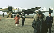 Iñupiat people at Barrow Airport, in front of a Wien Alaska Airlines Constellation  N7777G, circa 1966.