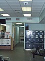 Lockers and Bell Canada payphones to the right, washrooms and employee door straign ahead, past the ticket counter at the Niagara Falls Transit Terminal. CCTV camera up above.