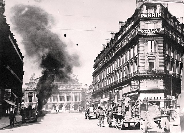 25 August – Armoured vehicles of the 2nd Armored (Leclerc) Division fighting before the Palais Garnier. One German tank is going up in flames.