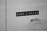 Badge on vehicle, reading "MB140D"