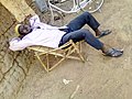 Man_resting_on_a_"lazy_chair"_made_of_nim_sticks_in_northern_ghana