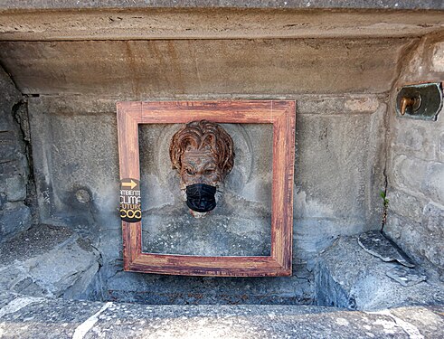 Mascherina sul mascherone di una fontana a Bibbiena (Toscana)