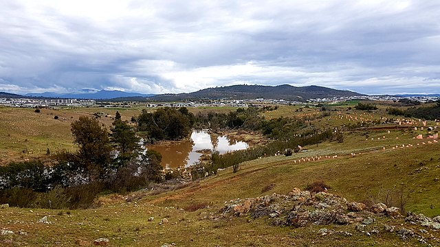 View of the Molonglo River from Barrer Circuit Trailhead. The suburbs of Coombs, Wright and Denman Prospect are viewable (L to R) against the backdrop