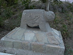 Ram-shaped grave monument embedded in concrete