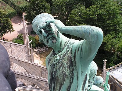 Statue of Thomas the Apostle, with the features of restorer Viollet-le-Duc, at the base of the spire