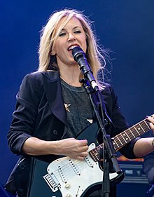 Liz Phair wrote "Spanish Doors" about a life falling apart, taking inspiration from a friend's divorce. OhanaSep18-99 (43410527210) (cropped).jpg