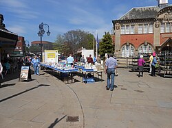 Outdoor market held in the square, with the Wrexham Old Library to the right.