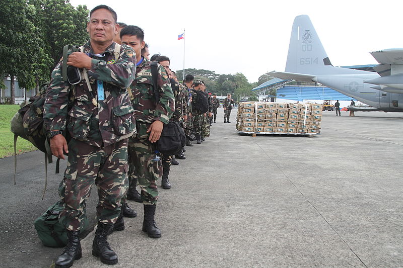 File:Philippine soldiers stand alongside a pallet of bottled water as they prepare to board a U.S. Marine Corps KC-130J Super Hercules aircraft at Villamor Air Base, Manila, Philippines, Nov. 11, 2013 131111-M-NV693-009.jpg