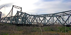 Le pont Alphonse-XIII en 2008, démonté et abandonné dans un pré à l'entrée du port[Note 1].