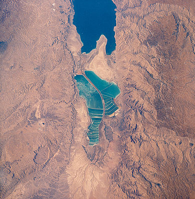 Aquesta fotografia del 1989, presa des del transbordador Columbia, mostra com el que havia estat la península de Lisan ha avançat fins a dividir el llac en dos a causa dels descens del nivell de l'aigua