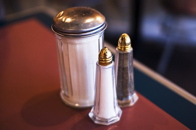 Salt, pepper, and sugar are commonly placed on Western restaurant tables.