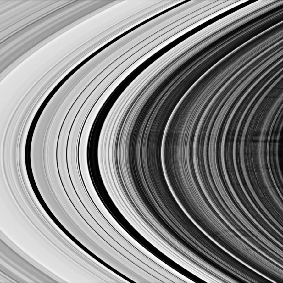 Dark B Ring spokes in a low-phase-angle Cassini image of the rings' unlit side. Left of center, two dark gaps (the larger being the Huygens Gap) and the bright (from this viewing geometry) ringlets to their left comprise the Cassini Division.