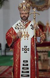 An Eastern Catholic Major Archbishop holding a blessing cross and an Eastern style crozier Sv shevchuk.jpg