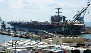 US Navy 110521-N-WX729-038 The aircraft carrier USS Theodore Roosevelt (CVN 71), assisted by tugboats, transits the James River to relocate from dr.jpg