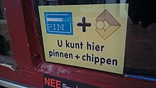 Sign outside of a merchant, stating "U kunt hier pinnen + chippen", loosely translated as "You can use pin and chip here" U kunt hier pinnen + chippen sign, Winschoten (2020) 02.jpg