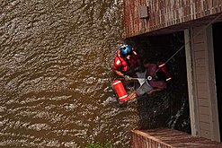 Successful rescue of a pregnant woman United States Coast Guard Scott D. Rady pulls a pregnant woman from her flooded New Orleans home.jpg