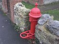 The red iron water pump at the southern end of Whitwell High Street.