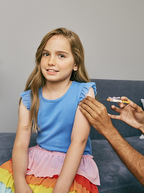 Girl about to be vaccinated in her upper arm