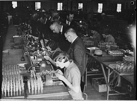 The late modern period saw extreme changes in the way people lived, including industrialization.  This photo shows women working on parts at an AWA factory in 1936, while men look on.