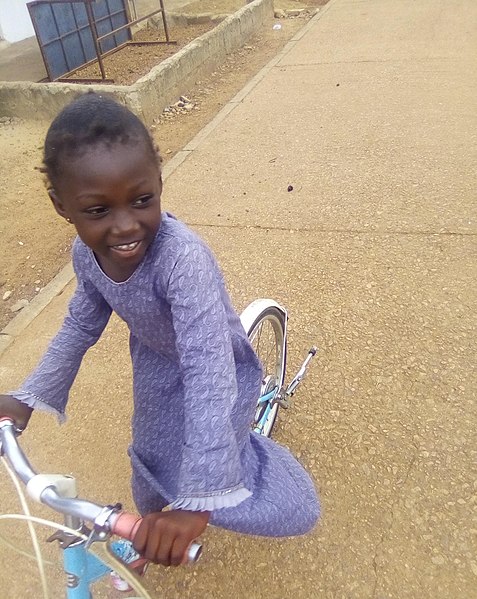 File:A young girl riding bicycle.jpg