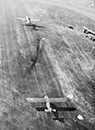 An aerial view of a C-47 Dakota as it tows off a CG-4A Waco glider from a British airfield en route for Holland. 17 September 1944