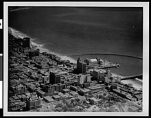 Long Beach in 1930. The Wise Company 1929 store can be seen at the left border, almost at the bottom. It has unadorned square edges topped by two square towers. Aerial view of the Long Beach Municipal Auditorium and surrounding area circa 1930.jpg