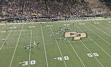 Cal Poly quarterback Sam Huard throws downfield during a win against Northern Colorado in the 2023 season. CalPolyFootballGameViewAboveIn2023.jpg