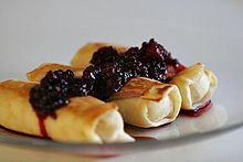 Cheese blintzes, typically eaten by Ashkenazi Jews on Shavuot Cheese blintzes with blackberries.jpg