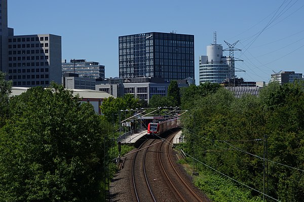 The new building of Deutsche Börse called The Cube in Eschborn above S-train station Eschborn Süd with DB class 423 as S 4, heading for Langen (above)