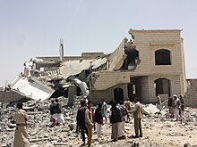 HRW wrote that the Saudi Arabian-led military intervention in Yemen that began on March 26, 2015, involved airstrikes in apparent violation of the laws of war. Destroyed house in the south of Sanaa 12-6-2015-3.jpg