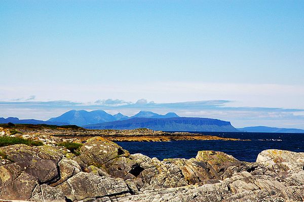 A distant view of Eigg, with the hills of Rùm behind.
