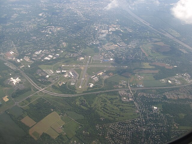 Aerial view of Ewing, looking southeast and featuring Trenton–Mercer Airport, Interstate 295, and the Delaware River