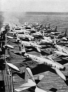 USAF Republic F-84 Thunderjet fighter-bombers bound for Japan photographed onboard the flight deck of Sitkoh Bay, August 1951. The aircraft are a part of the 12th Fighter-Escort Wing.