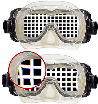 View of a rectangular grating through a flat-glazed diving half-mask, showing magnification and a detail of slight pincushion distortion and chromatic aberration in the through-water view.