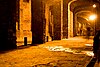 A tunnel under Guanajuato, a well lit passage under a series of stone arches with a stone floor